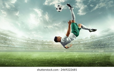 Dynamic cinematic shot of professional soccer athlete in action on stadium with flashlights, kicking ball in mid air for winning goal. Concept of professional sport, championship, tournament, match. - Powered by Shutterstock