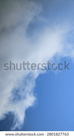 Dynamic cloud formation with wind-swept patterns in the sky.
