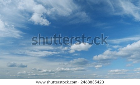 Dynamic cloud time-lapse from calm blue skies to cloudy. Puffy fluffy white clouds. Timelapse.