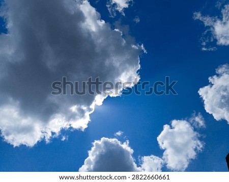 Dynamic cloudscape capturing heavy rolling clouds illuminated by faint horizon light at late dusk. Deep slate and cobalt shades build a captivating natural mood, perfect for dramatic nature backgrounds, weather reports, and creative stock photo visual artwork