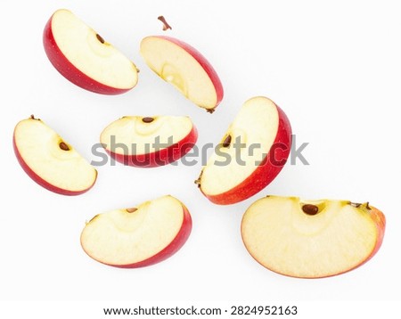 Dynamic Composition of Fresh Red Apple Slices Isolated on White