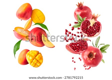 Dynamic composition set of flying fresh fruits. Levitating whole and scored mangoes and pomegranates falling in the air isolated on a white background.