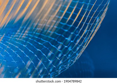 Dynamic Detail Of Abstract Airy Net And Orange Light Rays On Blue Background. Beautiful Mesh Of Azure Toned Fibers On Rastered Texture In Navy Shade. Artistic Grid For Technology, Research Or Science.