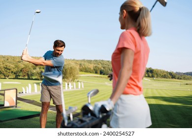 Dynamic Duo Practicing Golf Techniques