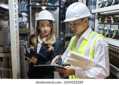 In the dynamic energy industry, the power plant is a vital hub where male and female engineers collaborate to optimize energy production and efficiency. - Powered by Shutterstock