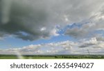 A Dynamic and EverChanging Cloudscape Over Serene and Lush Green Fields and Horizons
