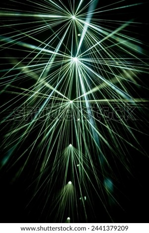 A dynamic explosion of green laser beams, electrifying the night with energy.