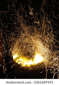 Dynamic Firey Sparks Background - A mesmerizing close-up of fiery sparks flying in all directions, illuminated by a vibrant orange and red glow.