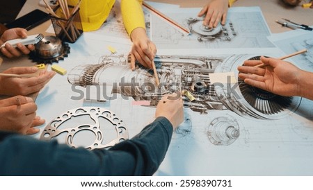 A dynamic group collaboration captures hands engaged in drawing details of a jet engine, showcasing teamwork and creativity in engineering design projects. SACTR