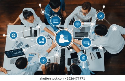 A dynamic group of professionals engages in collaborative discussions and technology-driven solutions while analyzing digital data in a modern office environment. Amity