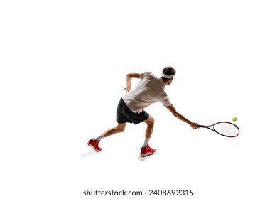 Dynamic image of concentrated young man, tennis player practicing, playing, hitting ball with racket isolated over white background. Concept of sport, hobby, active and healthy lifestyle, competition - Powered by Shutterstock