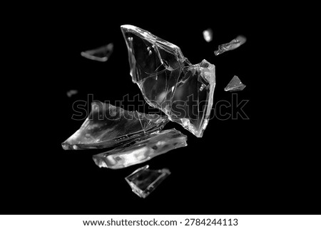 Dynamic image of sharp, transparent broken glass shards flying and floating against a solid black background. Perfect for abstract concepts.