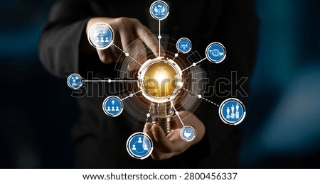 A dynamic image showcasing hands holding a glowing light bulb surrounded by technology icons, representing concepts of innovation, creativity, and business solutions in a digital context. Crux