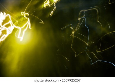 Dynamic Light Patterns in Green and Yellow Hues on Dark Background