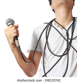 Dynamic Microphone In Asian Man Hand With Disorderly Cord On His Body, Isolated