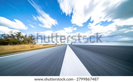 A dynamic perspective of an open road stretching towards the horizon, with clouds streaking across a vibrant blue sky, conveying a sense of speed and travel.