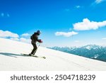 Dynamic picture of woman skier wear black isolated on piste ski downhill fast motion in Alps. Active winter holidays, skiing downhill in overcast day. Ski rides on the track with swirls of fresh snow