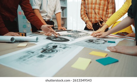 A dynamic planning session taking place in a modern office, featuring collaboration among diverse professionals analyzing blueprints, documents, and visual aids on a table. SACTR