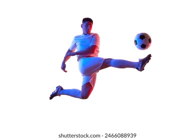 Dynamic portrait of young man, professional soccer player make perfect pass in mid-air in neon light against white studio background. Concept of professionals sport, competition, tournament, action. - Powered by Shutterstock