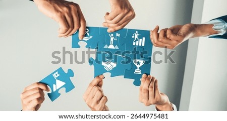 A dynamic representation of teamwork as multiple hands come together to fit puzzle pieces, symbolizing collaboration, success, and the pursuit of business goals in the workplace. Amity