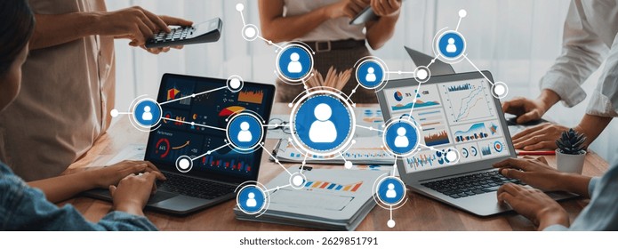 A dynamic scene depicting professionals engaged in a networking session using laptops and digital devices, emphasizing collaboration and data-driven strategies for modern business. Amity