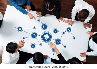 A dynamic scene of professionals working collaboratively on cloud computing ideas, using icons representing technology and connections, showcasing teamwork and innovation. Amity - Powered by Shutterstock - Get 15% off with code: PIKWIZARD15