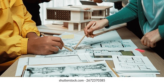 A dynamic scene showcasing a collaborative architecture meeting with professionals analyzing blueprints, sketches, and a scale model, emphasizing teamwork and creativity. SACTR