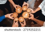 A dynamic scene showcasing diverse hands holding wooden gears with symbols of sustainability and innovation, highlighting collaboration in green business practices. Amity