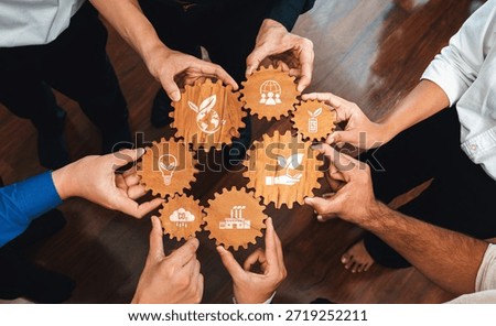 A dynamic scene showcasing diverse hands holding wooden gears with symbols of sustainability and innovation, highlighting collaboration in green business practices. Amity