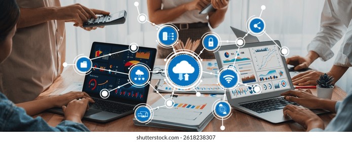 Dynamic scene showcasing teamwork with laptops displaying data visualizations and cloud networking concepts. Ideal for illustrating modern technology in business settings. Amity