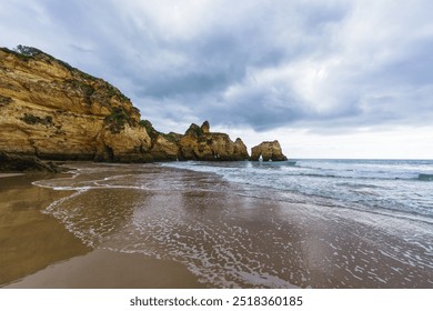 Dynamic seascape with rocky arches and caves, where relentless ocean waves clash against the shore beneath a dramatic, overcast sky - Powered by Shutterstock