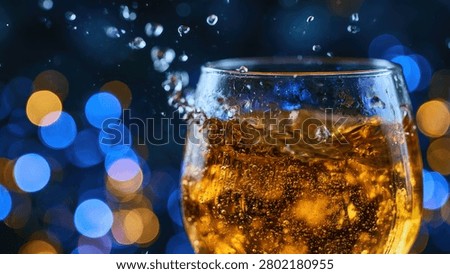 A dynamic shot capturing a glass filled with a golden beverage, showing effervescence and splashes against a blurred background of festive lights.