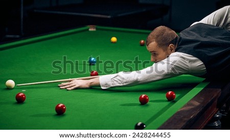 Dynamic shot of a player making shot, expressing energy and excitement for promoting billiards championship and local tournaments. Snooker game. Concept of billiards sport, gambling, hobby, leisure