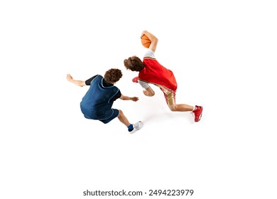 Dynamic shot of two young basketball athletes training their skills against white studio background. Aerial view. Concept of professional sport, competition, match, team games. Ad - Powered by Shutterstock