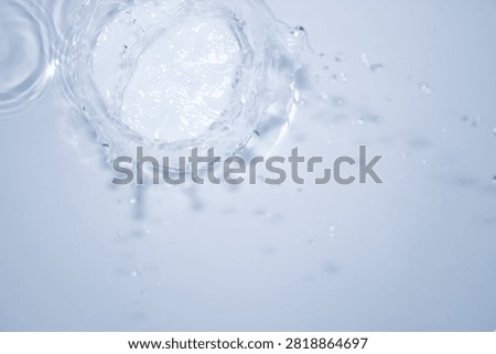 Dynamic splash of water creating ripples on a smooth surface, capturing the essence of clarity and movement. Ideal for various thematic applications.