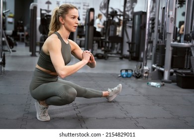 Dynamic stretching of young caucasian woman on a gym - Powered by Shutterstock