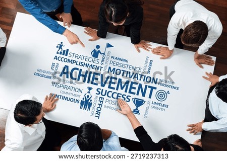 A dynamic team collaborates around a table, brainstorming achievement strategies. The focus is on motivation, success, and persistence, fostering innovation in the workplace. Amity