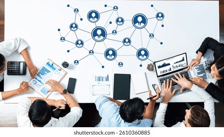 A dynamic team collaborates to develop networking strategies and analyze data insights using technology tools in a modern workspace setting. Amity
