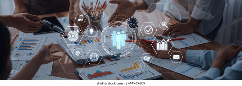 A dynamic team collaborates in an office setting, discussing graphs and strategies, highlighting the impact of technology on business growth and decision-making. Trope