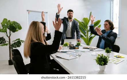 A dynamic team engaged in a collaborative discussion in a modern office setting, emphasizing teamwork and innovation. The team rejoices at a successful deal or win. Team building, startup.