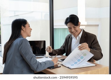 Dynamic teamwork. Professionals enjoying a collaborative session while discussing financial insights.