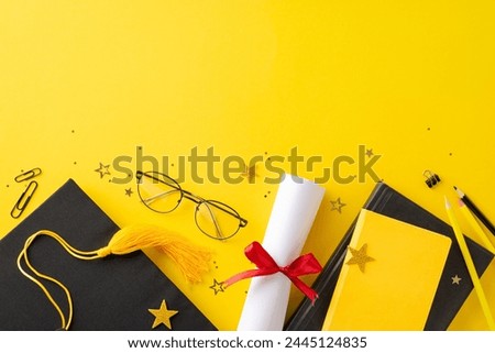 Dynamic top view arrangement featuring graduation cap, diploma, stationery, books, confetti on yellow backdrop, compelling image for conveying graduation excitement or advertising educational offering