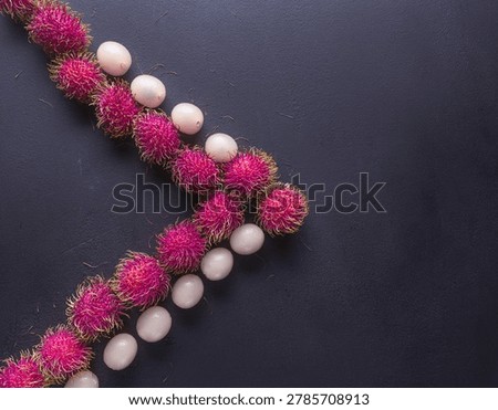 A dynamic, top-down chevron layout alternating between whole, spiky neon-pink rambutan shells and completely peeled, glassy-white fruit spheres. The sharp contrast between the aggressive, hair-like exterior texture and the hyper-smooth interior flesh delivers immense tactile depth.