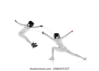In dynamic training session, two female fencers clash swords, each testing other's defenses against white studio background. Concept of professional sport, competition, strength and power, action. Ad