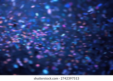 A dynamic and vibrant background featuring a multitude of out-of-focus blue and purple bokeh lights, creating a sense of depth and movement.