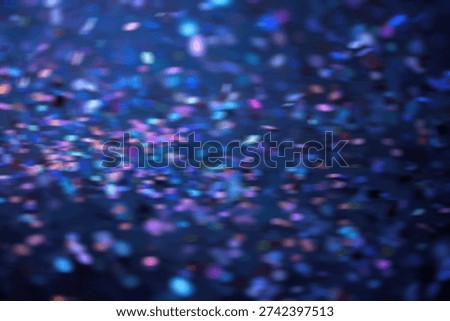 A dynamic and vibrant background featuring a multitude of out-of-focus blue and purple bokeh lights, creating a sense of depth and movement.