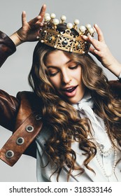 dynamic woman in brown leather jacket with golden crown 