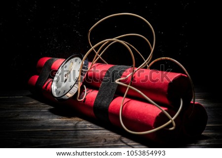 Dynamite bomb with a timer, and a bunch of dynamite on black background. Dynamite is going to explode or detonate per 1 second.