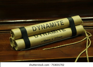 Dynamite stick isolated on wooden table
