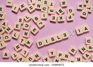 dyslexia concept - alphabet letters on pink background